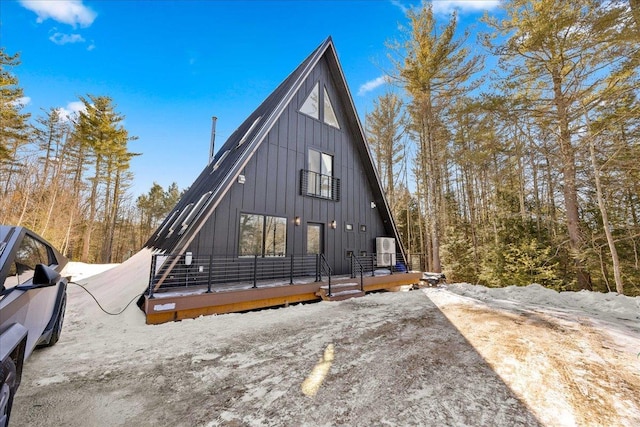 view of front of home with board and batten siding and cooling unit