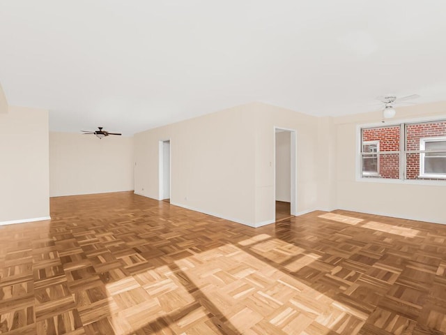 spare room featuring baseboards and a ceiling fan