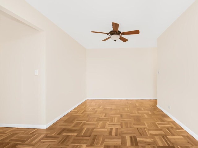 unfurnished room with ceiling fan and baseboards