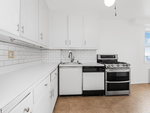 kitchen featuring range with two ovens, dishwasher, light countertops, white cabinetry, and a sink