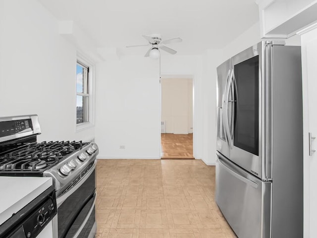 kitchen with light floors, appliances with stainless steel finishes, light countertops, and a ceiling fan