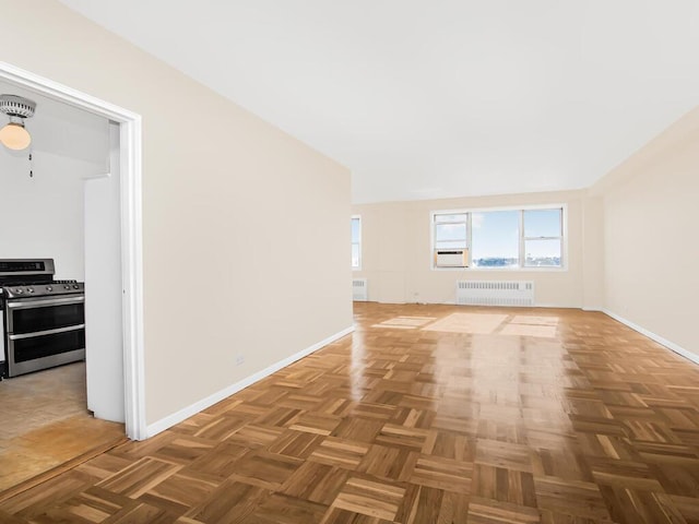 empty room with cooling unit, radiator, and baseboards