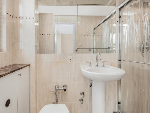 full bath featuring a stall shower and tile walls