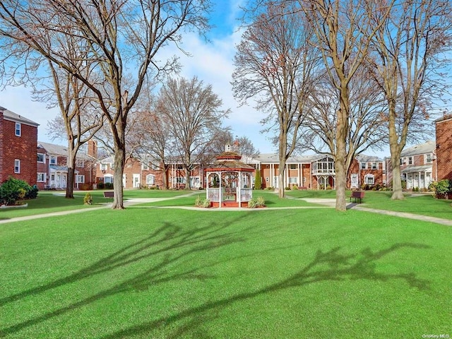 surrounding community with a yard and a residential view