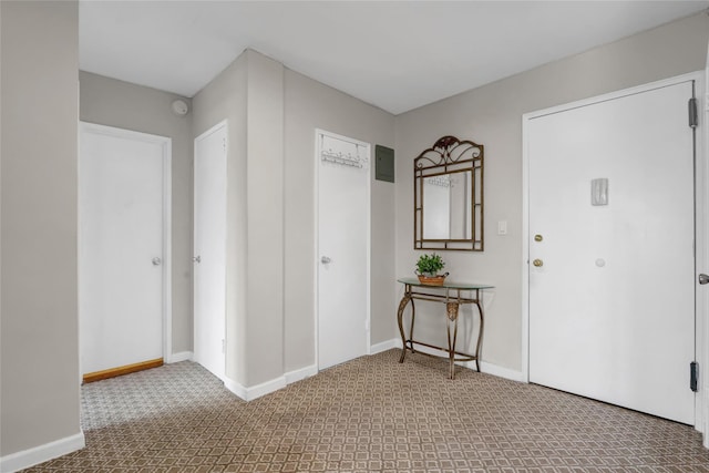 carpeted entryway with baseboards