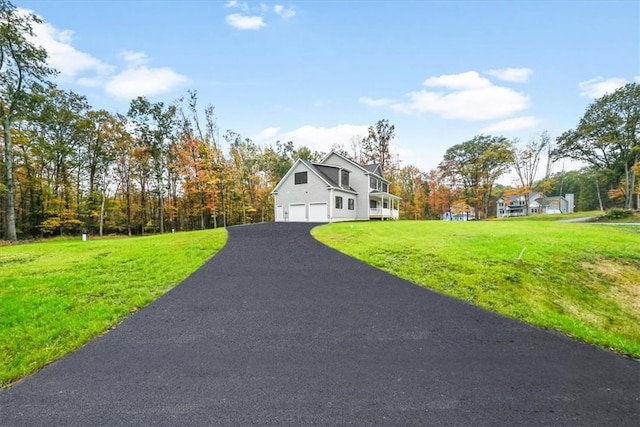 view of front of house featuring driveway and a front lawn