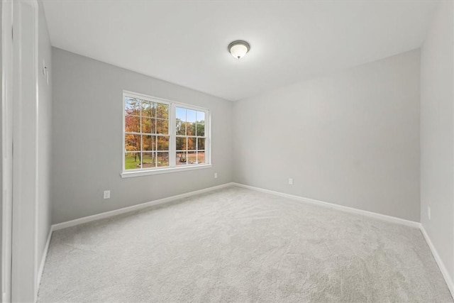 spare room with carpet flooring and baseboards