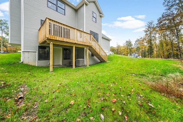 back of house with cooling unit, a lawn, a deck, and stairs