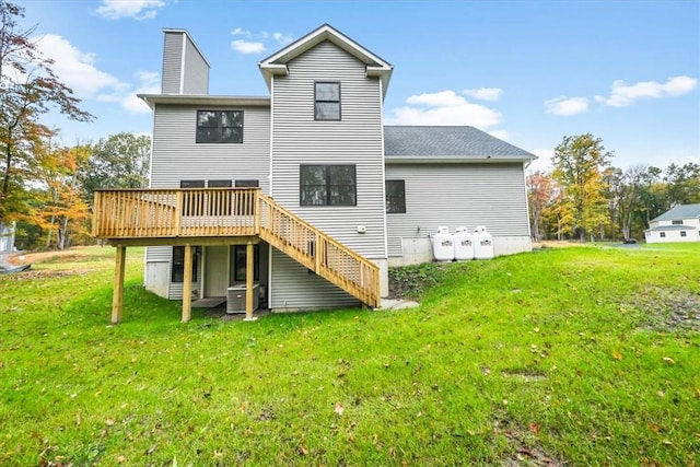 back of property featuring a lawn, a chimney, a wooden deck, and central AC unit