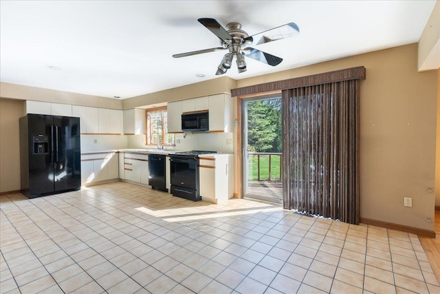515 Corey Creek Ln, Southold, NY 11971 - kitchen with white cabinets, black appliances, a ceiling fan, and light countertops
