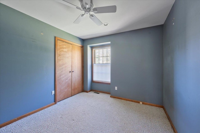 515 Corey Creek Ln, Southold, NY 11971 - unfurnished bedroom with a closet, carpet flooring, baseboards, visible vents, and a ceiling fan