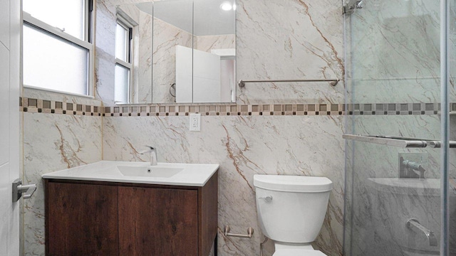 bathroom featuring toilet, a shower, and vanity