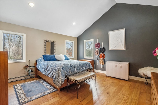 bedroom featuring light wood-style floors, baseboards, vaulted ceiling, and baseboard heating