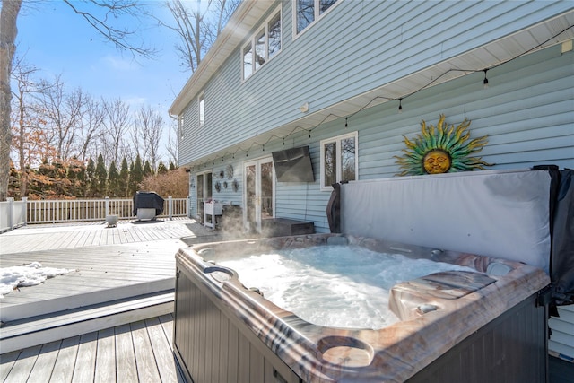 wooden deck featuring a hot tub