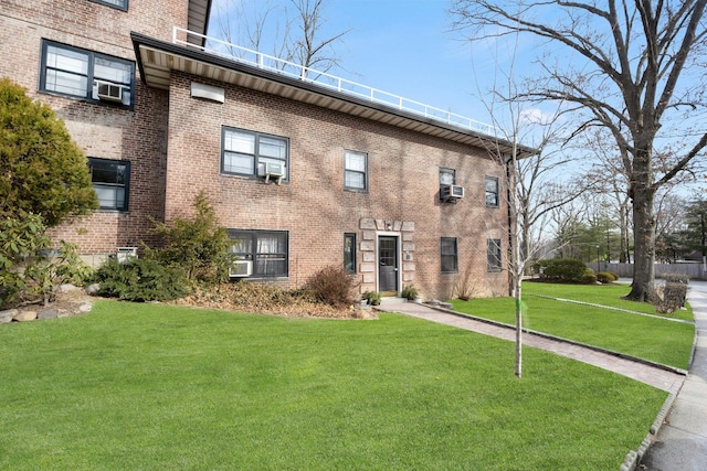 view of front of house with a front lawn and brick siding