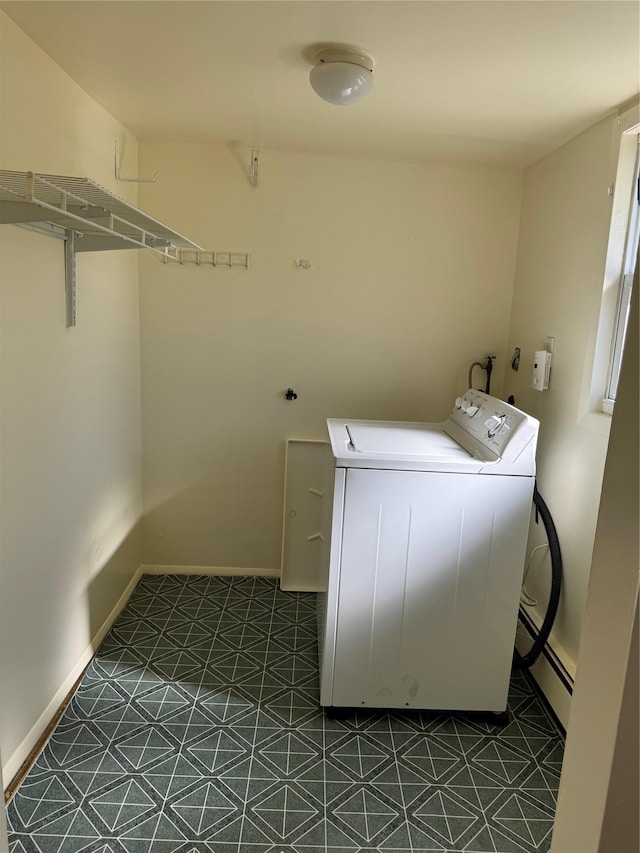 washroom with laundry area, baseboards, dark floors, and washer / clothes dryer