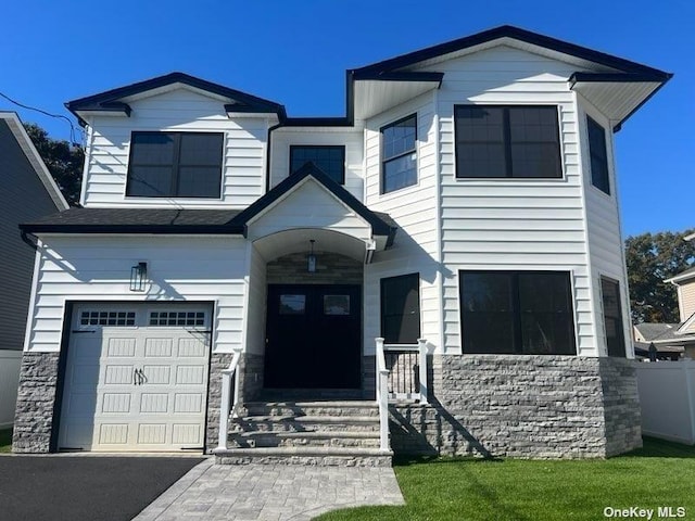 view of front of house with a garage and stone siding