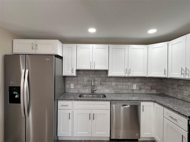 kitchen with tasteful backsplash, recessed lighting, appliances with stainless steel finishes, white cabinetry, and a sink