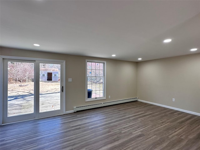 spare room featuring recessed lighting, baseboards, dark wood finished floors, and baseboard heating