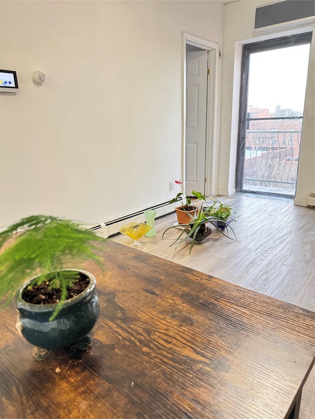 interior space with a baseboard radiator and wood finished floors