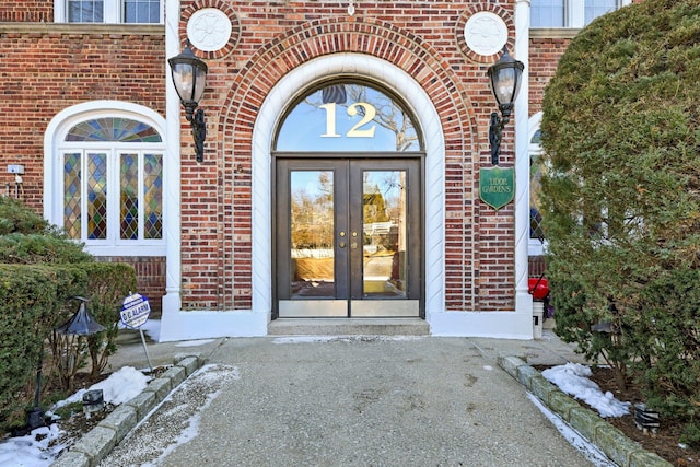 property entrance with brick siding and french doors