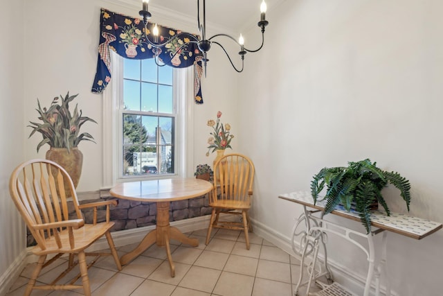 dining room with light tile patterned floors, baseboards, breakfast area, ornamental molding, and a chandelier