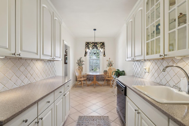 kitchen featuring a sink, glass insert cabinets, and white cabinets