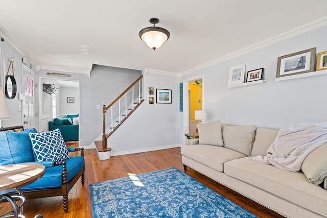 living room featuring ornamental molding, stairway, wood finished floors, and baseboards