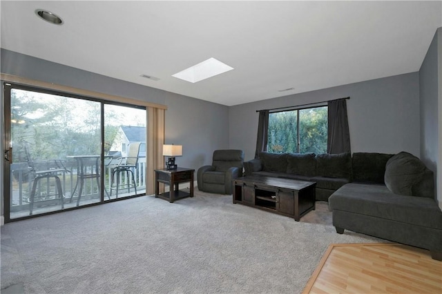 living room featuring a skylight