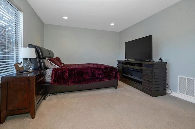 bedroom featuring recessed lighting, visible vents, and light colored carpet