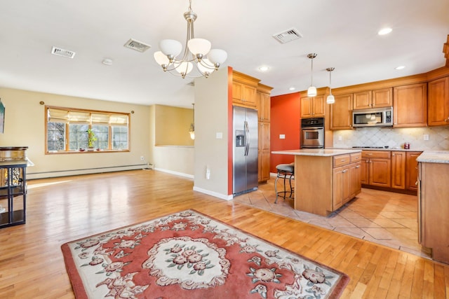 kitchen featuring a baseboard radiator, visible vents, and stainless steel appliances