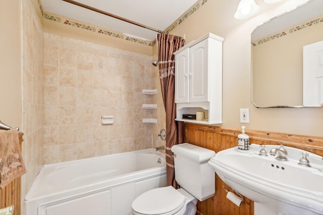 full bath featuring toilet, shower / tub combo, and a sink