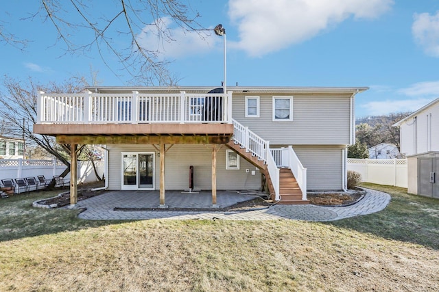 back of property featuring stairs, a yard, a patio, and a wooden deck