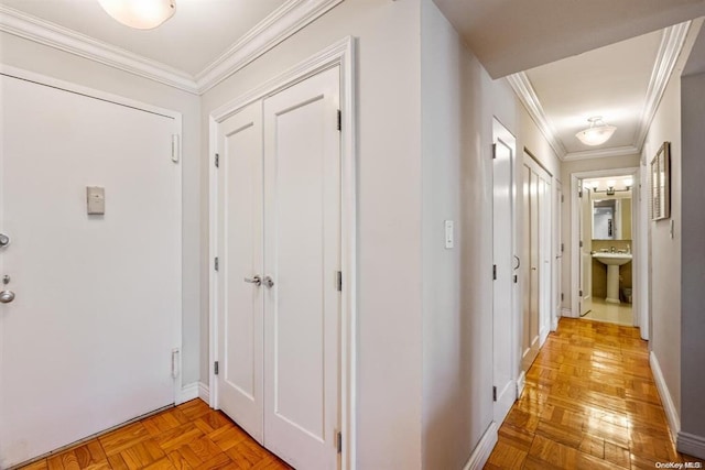 hallway with baseboards and crown molding