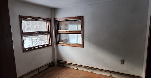 spare room with wood finished floors