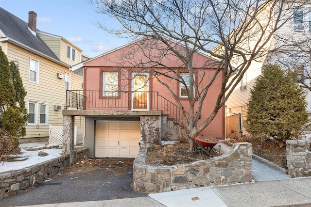 view of front facade featuring aphalt driveway and an attached garage