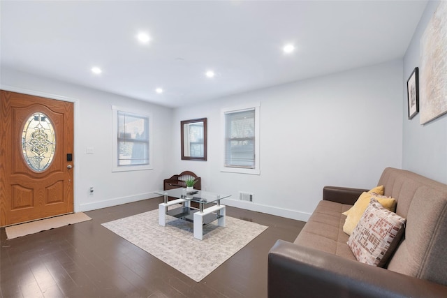 living area featuring dark wood-style floors, visible vents, baseboards, and recessed lighting