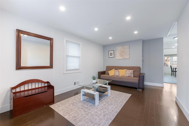 living room with baseboards, dark wood finished floors, visible vents, and recessed lighting