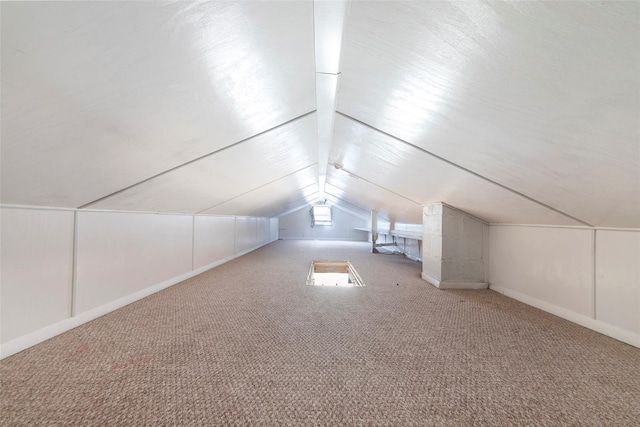 bonus room featuring lofted ceiling and carpet