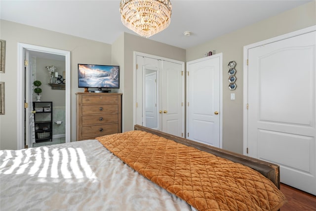 bedroom featuring an inviting chandelier and a closet