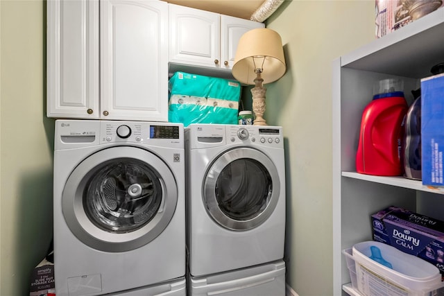 washroom with cabinet space and independent washer and dryer