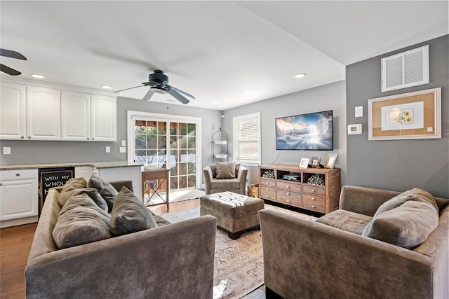 living room featuring recessed lighting, wood finished floors, visible vents, and a ceiling fan