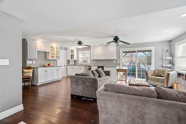 living room featuring baseboards, dark wood finished floors, a ceiling fan, and recessed lighting