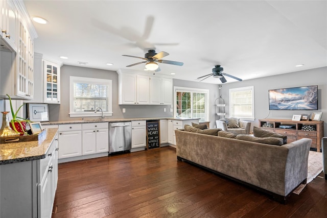 living room featuring beverage cooler, dark wood finished floors, a wealth of natural light, and recessed lighting