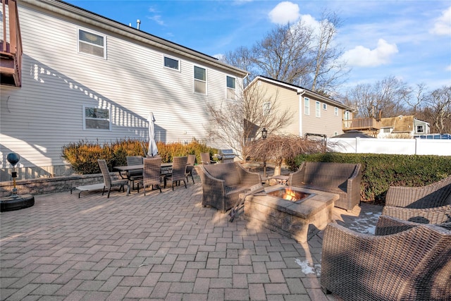 view of patio featuring an outdoor fire pit, fence, and outdoor dining space