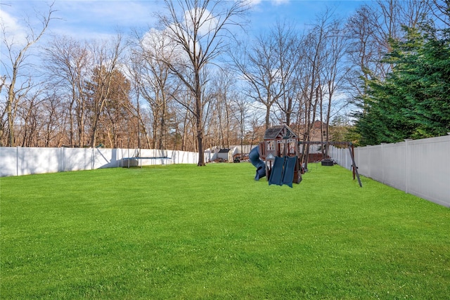 view of yard featuring a playground and a fenced backyard