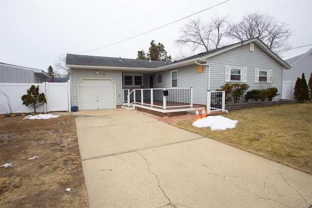 ranch-style home with a garage, concrete driveway, a front lawn, and fence