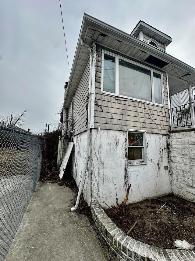 view of home's exterior featuring fence