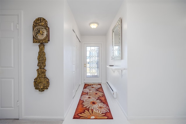 doorway with a baseboard radiator and baseboards