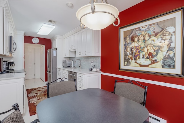 dining area with a baseboard heating unit and visible vents